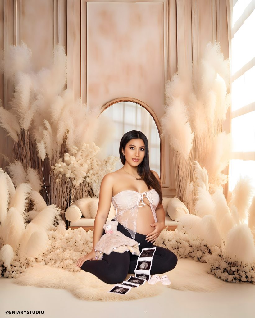Soft neutral maternity portrait with ultrasound photos and pampas decor