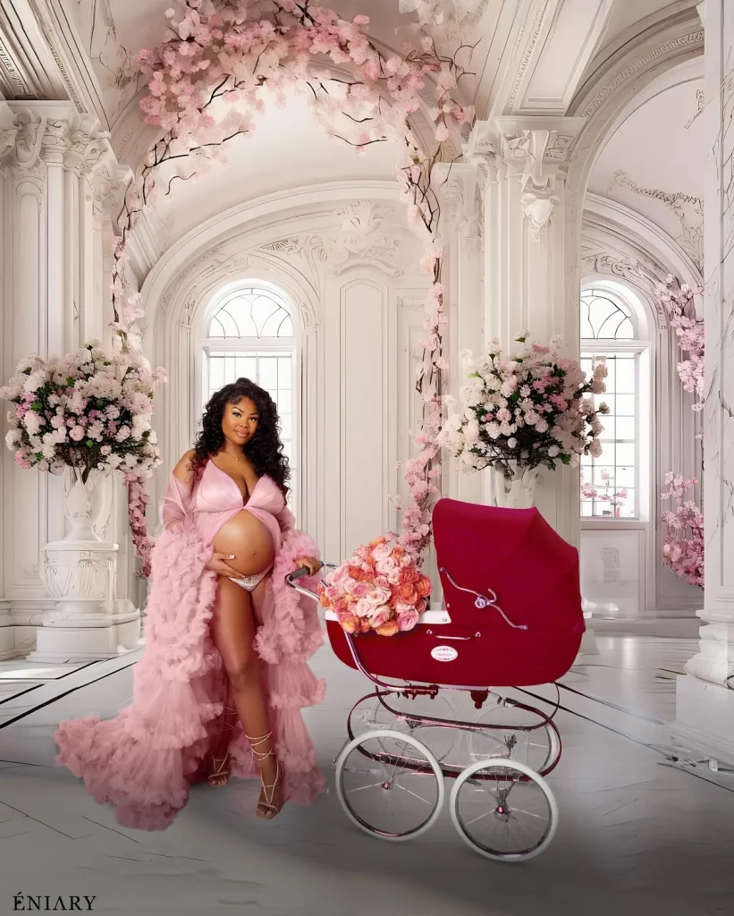 Maternity portrait in a pink ruffle gown inside an ornate luxury room