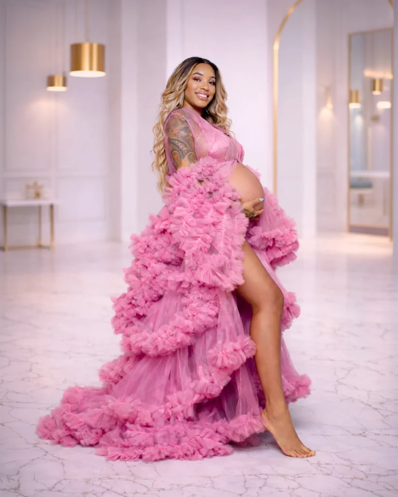 pregnant woman wearing hot pink ruffle maternity gown posing during maternity photoshoot