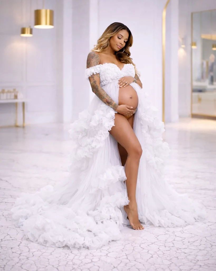 pregnant woman wearing white ruffle maternity gown posing in luxury maternity photoshoot