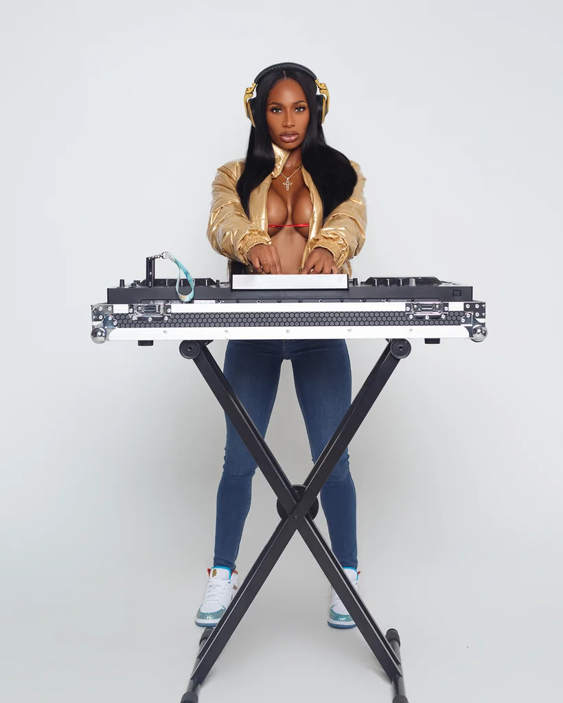 Female DJ posing with professional music equipment during a personal branding photoshoot