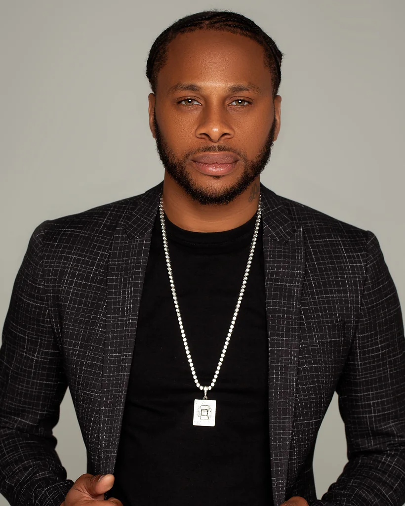 Male entrepreneur in a dark blazer photographed for a polished personal branding headshot