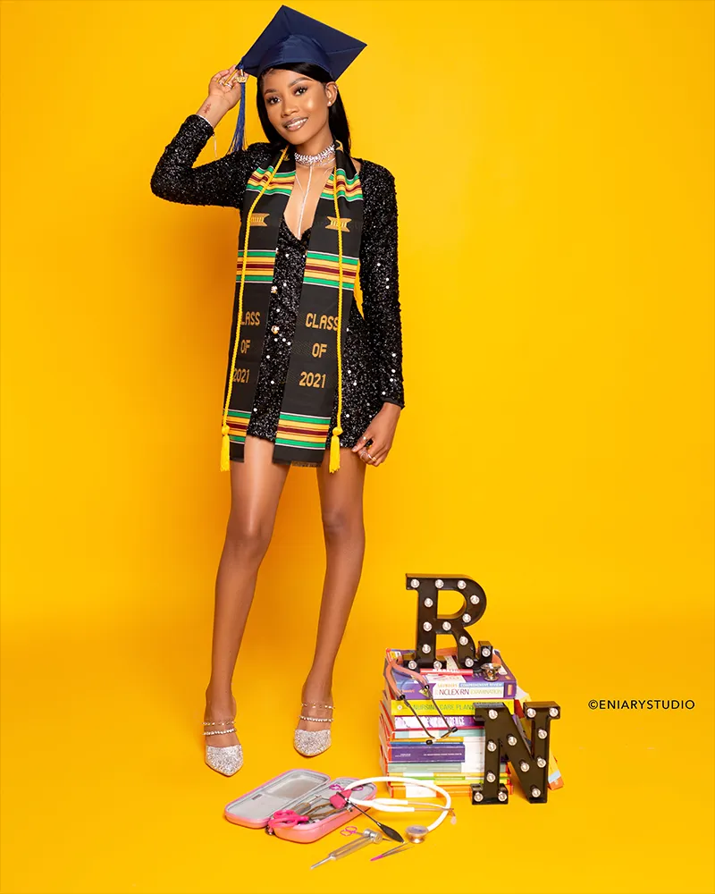 Nursing graduate portrait with school and career props