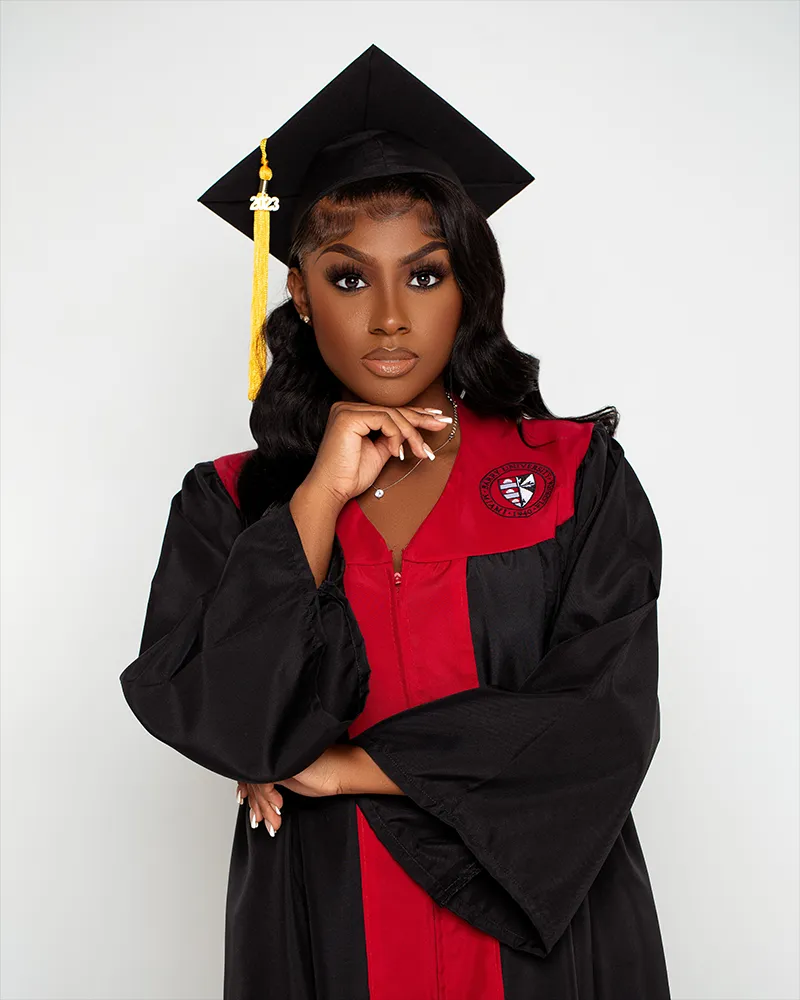 Female graduate in black and red cap and gown